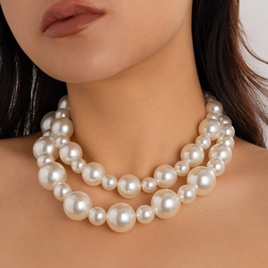 Double-layered oversized pearl choker necklace with vintage glossy finish on female model