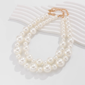 Detailed view of double-layer choker with white gradient pearls and gold lobster clasp