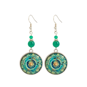 Macro detail of ethnic mandala earrings with green beads and silver hooks