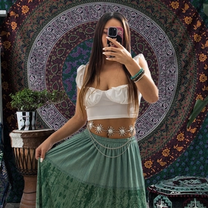 Bohemian silver sun flower metal waist chain with layered chains on a female model