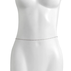 Detail of slim silver bead body chain on mannequin for sexy beach waist decoration