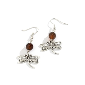Detail of vintage dragonfly earrings with brown translucent beads and silver alloy finish