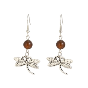 Detailed view of vintage silver dragonfly earrings with translucent brown beads