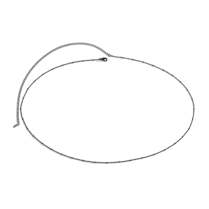 Minimalist black beaded single layer body chain with adjustable lobster clasp on white background