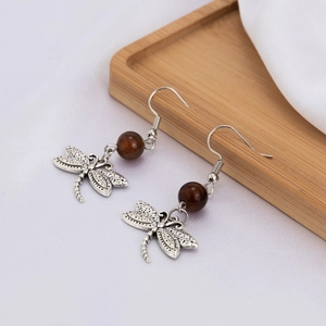 Vintage silver dragonfly dangle earrings with brown beads and intricate filigree details