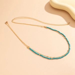 Chaîne de taille bohème dorée avec perles turquoise et coquillages pour la plage