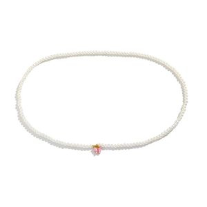 Detailed view of white faux pearls chain with a pink butterfly pendant and gold accents