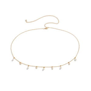 Detailed view of golden body chain with white faux pearls and crystal rhinestone tassels