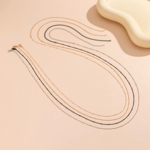 Set of four minimalist satellite chain waist necklaces in gold, rose gold, black, and silver