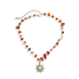 Detailed shot of sun pendant necklace with irregular colorful natural stone chips