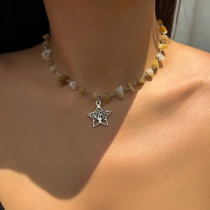 Macro detail of dopamine style mushroom necklace with colorful stones and star pendant