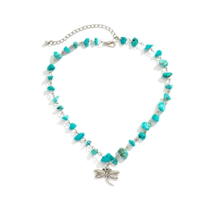 Detail of turquoise beaded necklace featuring a vintage silver dragonfly charm pendant