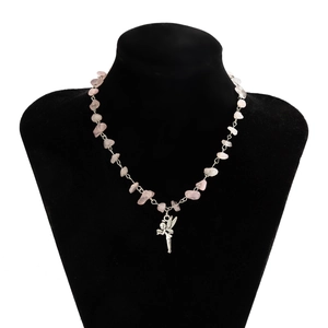 Detailed shot of pink crushed stone necklace with silver fairy pendant on model