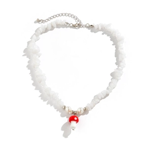 Detail of beaded necklace with white stones, pearls and red mushroom pendant