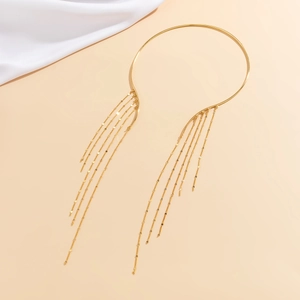 Detail of gold choker necklace featuring long tassels with small round sequins on cream silk