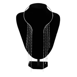 Macro view of silver punk choker with long metal tassels and bead accents on a black stand