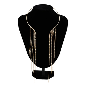 Detail of gold metal choker featuring cascading tassel fringe and round sequin charms