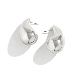Macro shot of silver chunky teardrop earrings with high-polish metallic finish