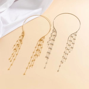 Detail of gold and silver choker necklaces with long metallic fringe and star accents