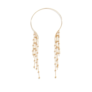 Detail of gold choker with long tassel chains and small star charms on white background
