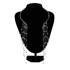 Close-up of silver punk collar with long star tassel chains on a display mannequin