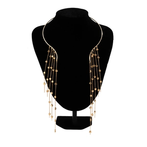 Detail of gold choker body jewelry with fringe metal chains and small star pendants