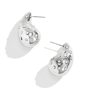 Close-up of silver drop earrings with mirror polish and crystal rhinestone inlays