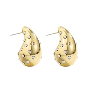 Detailed close-up of golden teardrop earrings with symmetric white zircon stone inlay
