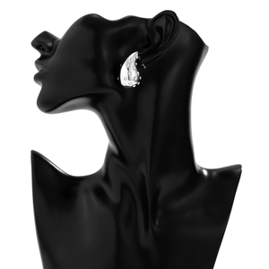Detail of silver waterdrop earrings with inlaid sparkling rhinestones on black display