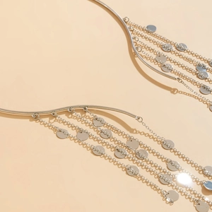Macro shot of silver body chain with multi-layer fringe tassels and round metal sequins
