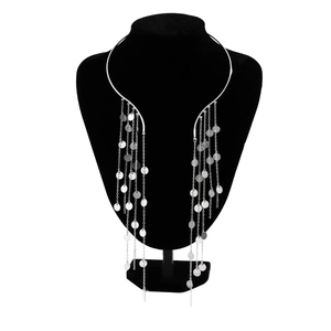 Close-up of silver punk choker with long metal tassel chains and round sequins