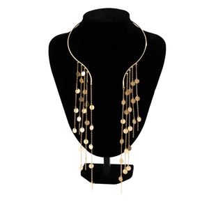 Punk style gold fringe choker necklace with metallic sequins on a black display stand