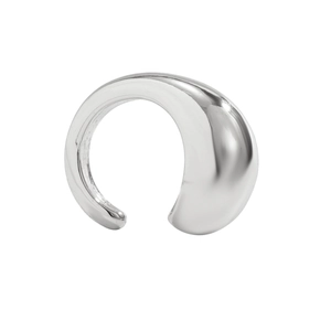 Macro shot of silver C-shaped ear cuff with high-polished metallic mirror finish