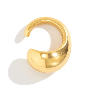 Detail of high-polish gold chunky C-shaped metal earring with sharp profile shadows