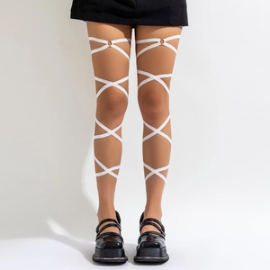 Detailed view of white elastic leg wraps with metal rings on a model with black shoes