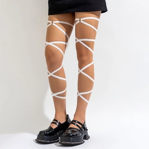 Macro detail of white elastic cross strap leg chain with metal ring and platform shoes