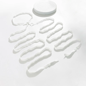 Detail of white wave elastic band with S-shaped edges and soft nylon texture