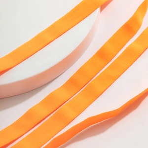 Close-up detail of orange elastic leg chain webbing with horizontal woven texture