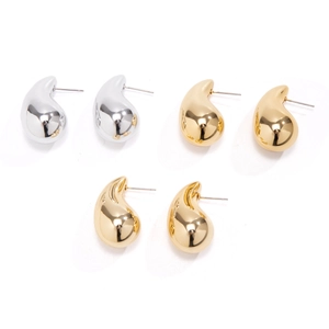 Detailed view of polished teardrop earrings in metallic gold and silver finishes