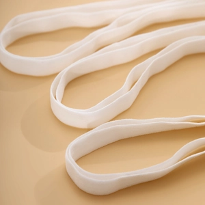 Macro view of pure white elastic leg chain strap with detailed knitted texture
