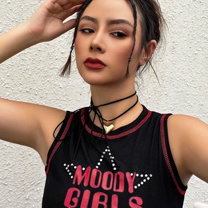 Close-up of black choker with gold heart pendant and Moody Girls rhinestone tank top