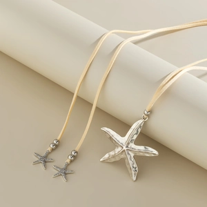 Detailed close-up of a bohemian starfish pendant necklace with a vintage silver finish