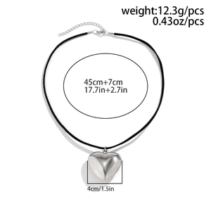 Detail of silver heart pendant on black velvet cord necklace with measurements