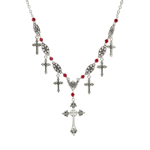Detailed macro view of Gothic silver cross pendants with red bead accents on necklace
