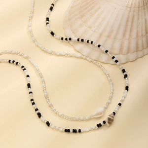 Detail of double-layer seed bead body chain with sea shell and starfish pendants