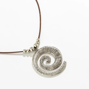 Macro view of a vintage silver conch snail shell pendant with brown cord and silver beads