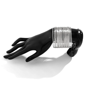 Detail of silver multi-layer wire wrapped cuff bracelet on black model hand stand