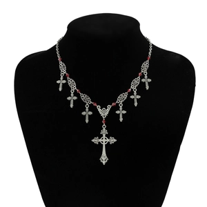 Gothic silver cross pendant necklace with red beads on a black mannequin display