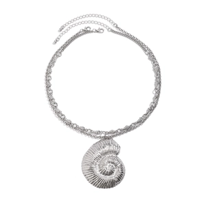 Detailed close-up of multilayer silver necklace with a nautilus shell spiral pendant