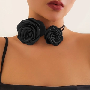 Detail of handcrafted black fabric roses on a minimalist cord choker for women